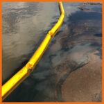 10" creek and swamp boom deployed around a thick oil spill to prevent spread