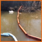 10" creek and swamp boom deployed in a creek to keep oil from spreading further