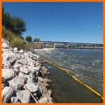 10" boom deployed near rocky shoreline to protect it from oil