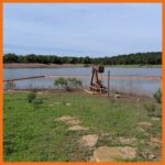 18" contractor boom deployed around an oil pump to prevent spilled oil from spreading