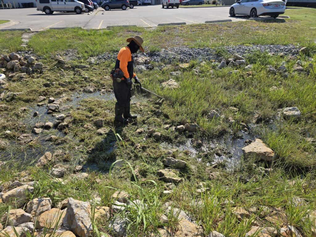 ACME spill tech removing contaminated grass from affected area