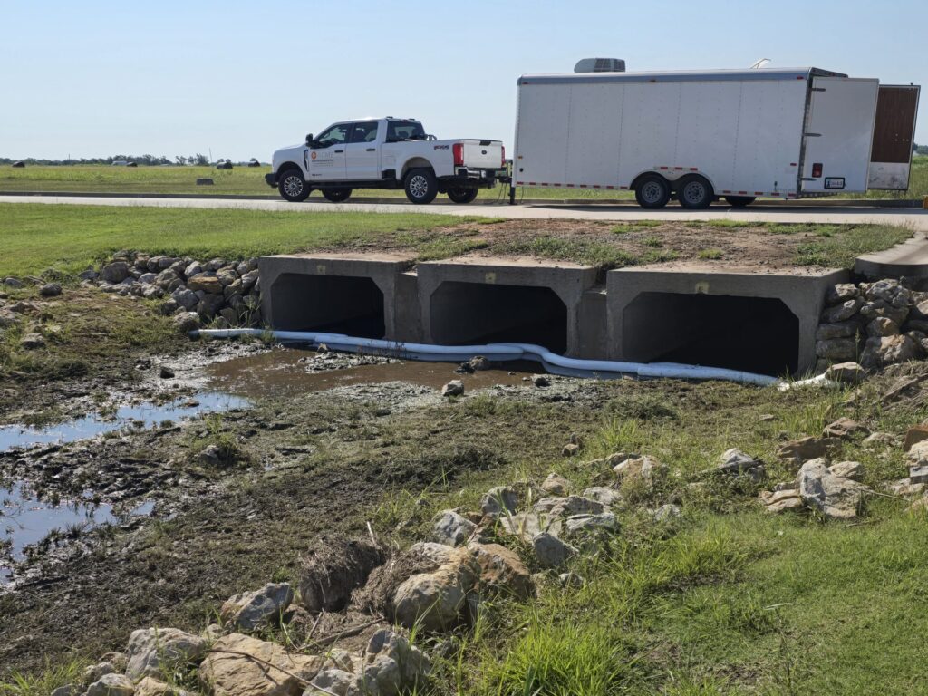 Sorbent boom deployed near culvert to prevent further spread of oil