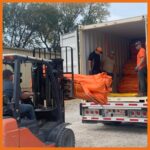 ACME workers loading Containment Boom into containers to be shipped