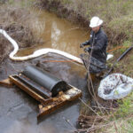 Oil drum skimmer cleaning up thick oil spill