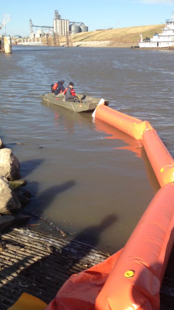A picture of ACME employees deploying Inflatable Boom