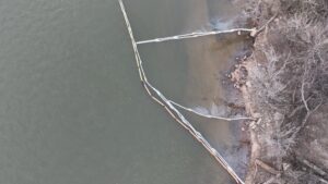 Footage from an ACME drone of a legacy oil spill that is slowly leaking into a river