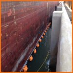 Perma Boom deployed between a ship and docking station