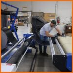 Perma boom pvc material being loaded onto cut machine