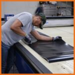 ACME employee cutting perma boom to exact length