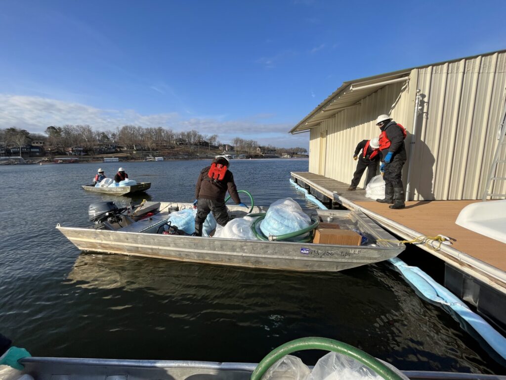 ACME employees responding to an oil spill on a lake in February