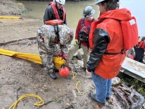 Buoys Being Attached to Containment Boom End Connectors