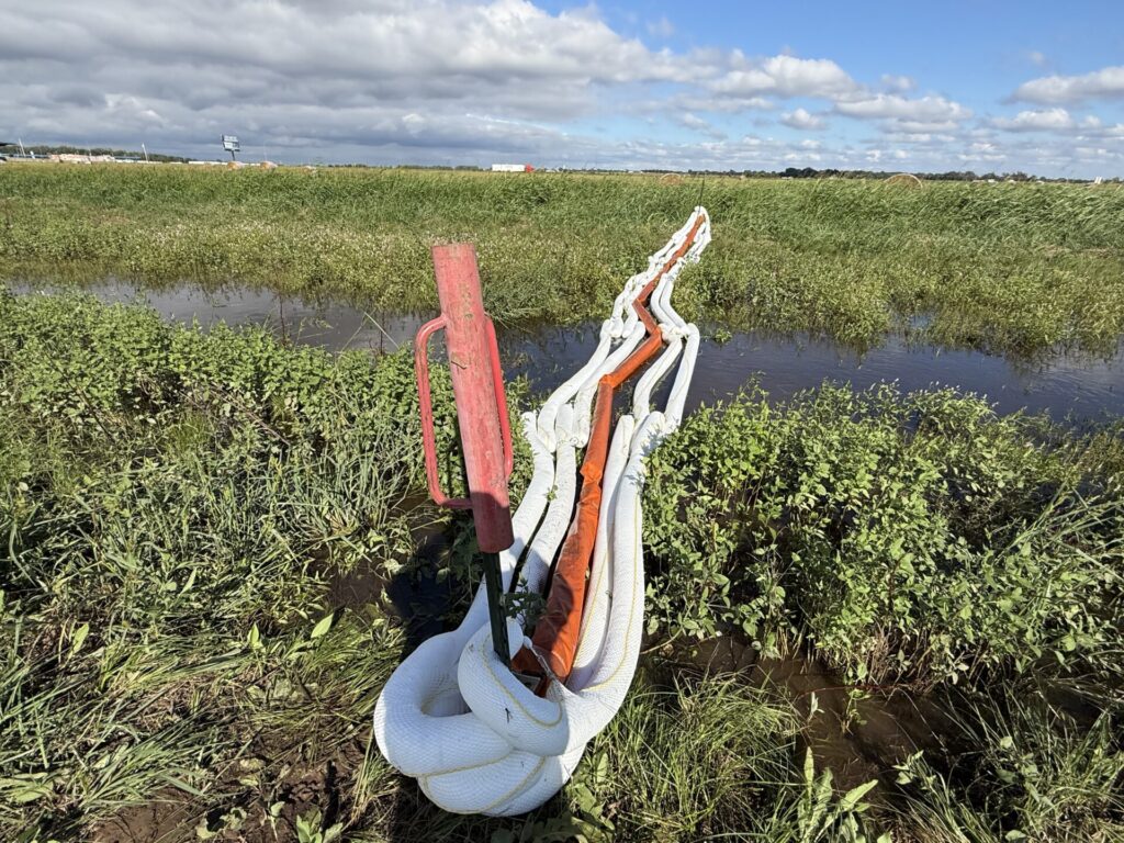 Oil containment boom and sorbent boom deployed down river of affected area to prevent further spread of oil