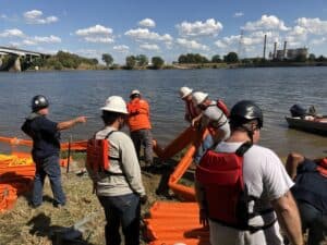 Giving hands-on containment boom deployment training.