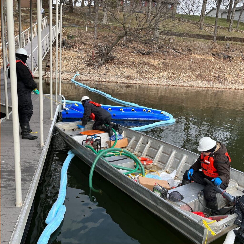 A picture of absorbent boom deployed around a boat dock to prevent oil from spreading