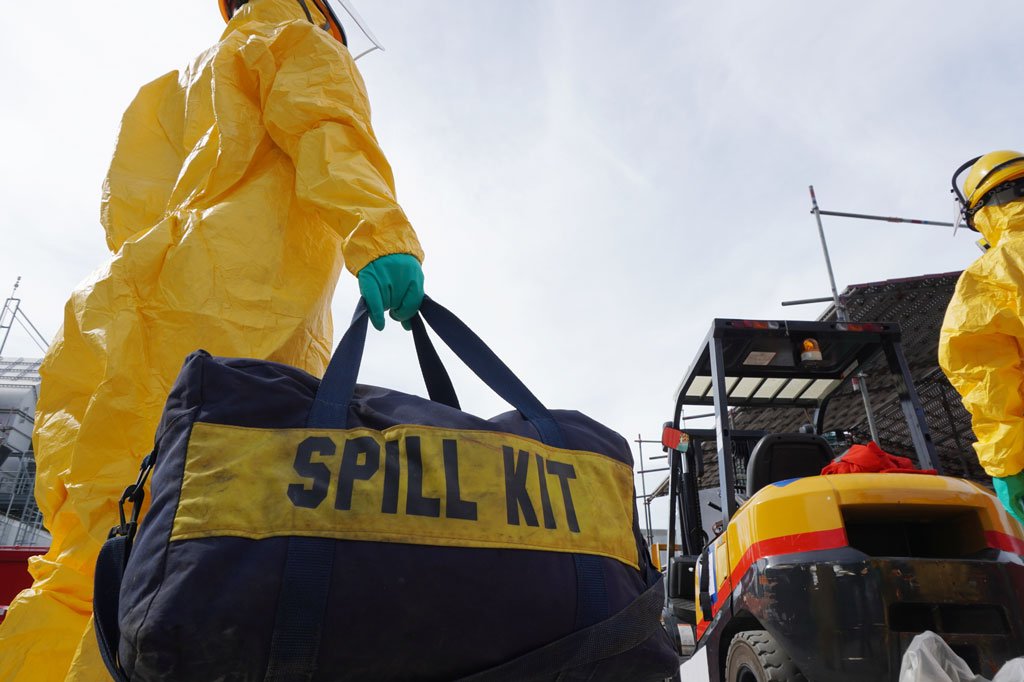 Oil spill responders going onto the scene with a spill kit to clean up an oil spill.