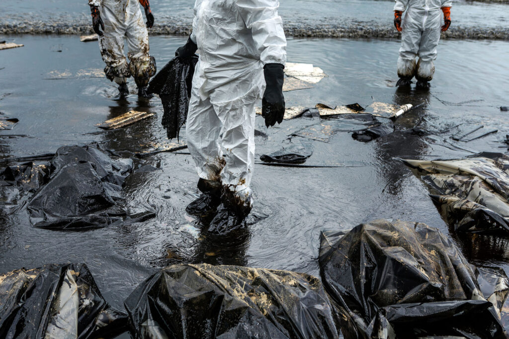 Oil spill responders using sorbents to clean up an oil spill.